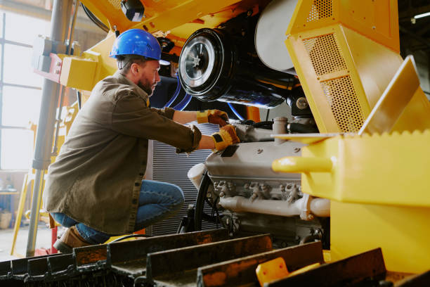 technician fixing parts of heavy machine